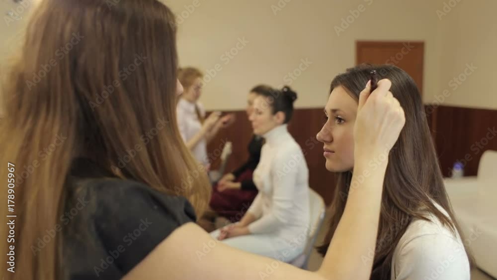 Team of professional makeup artists working with models. Team of professional makeup artists working with models.
