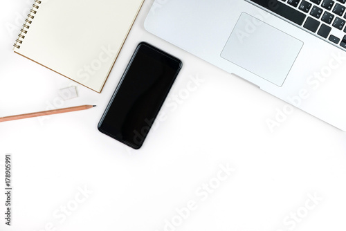 Business office work desk table with computer laptop , note and stationery on white table background include copyspace for add text or graphic