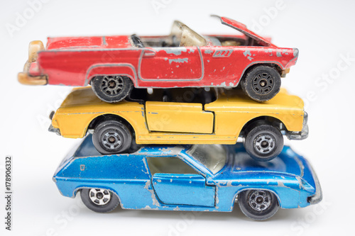 Child s old toy cars in primary colors of red  yellow and blue