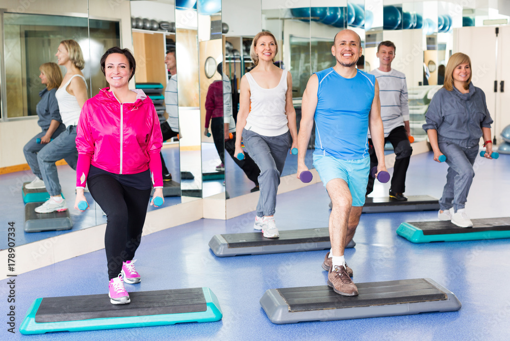 Fototapeta premium People do pilates with dumbbells