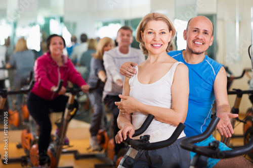 Elderly couple exercising in gym