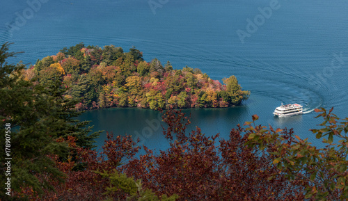 Hacchodejima promontory and sight seeing boat in lake Chuzenji, Nikko, Japan. photo