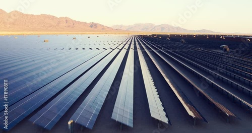 Aerial shot over solar panels in desert sun