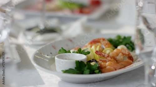 Shot of perfect dishes on plates on banquet table at restaurant photo