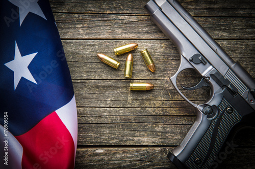 Pistol bullets, handgun and USA flag. photo