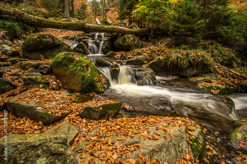 Waterfall in an autumn forest as a time exposure