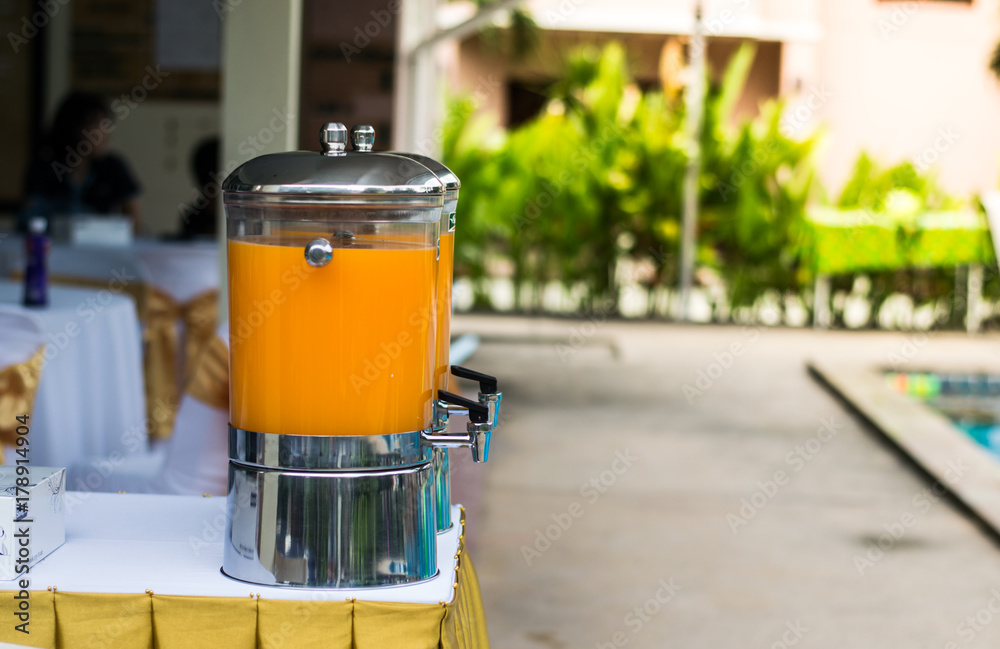 big bottle with orange juice ready to serve for party