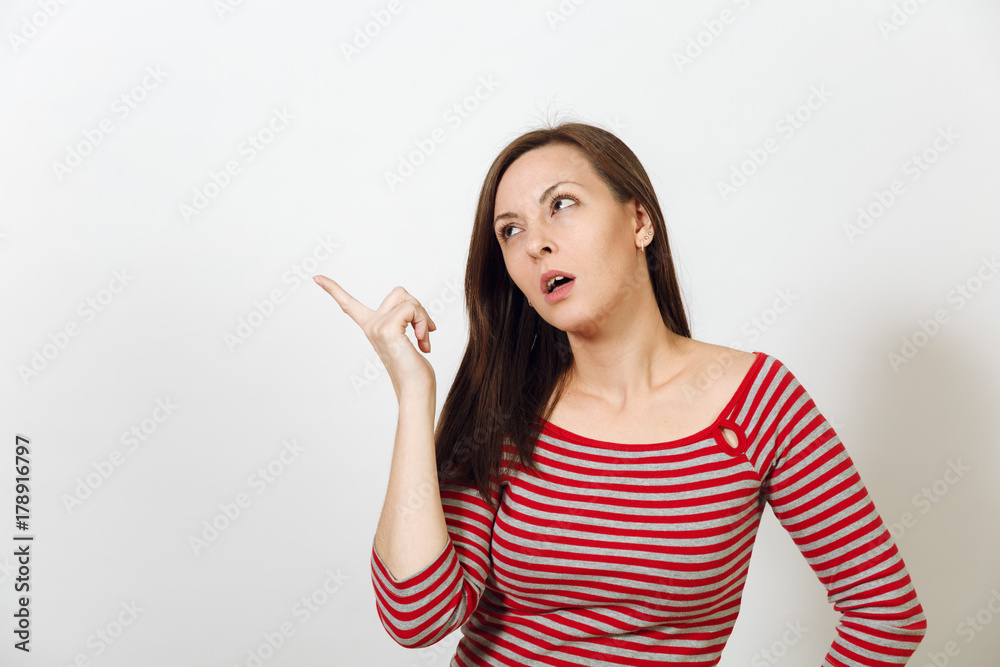 Pretty European young worried and pensive brown-haired woman with healthy clean skin, dressed in casual red and grey clothes lost in thought and conjectures, on a white background. Emotions concept. Pretty European young worried and pensive brown-haired woman with healthy clean skin, dressed in casual red and grey clothes lost in thought and conjectures, on a white background. Emotions concept.