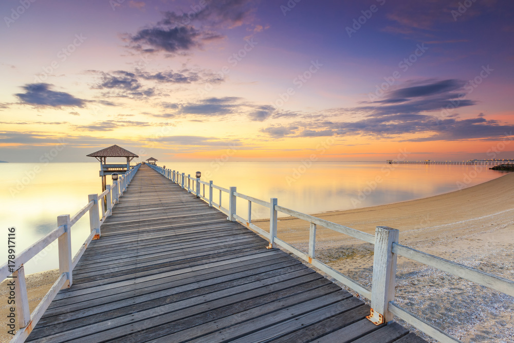 Old wood bridge pier  against beautiful sunset sky use for natural background ,backdrop and multipurpose sea scene