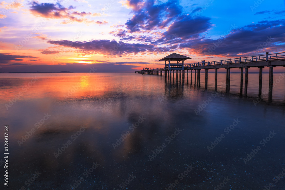 Old wood bridge pier  against beautiful sunset sky use for natural background ,backdrop and multipurpose sea scene