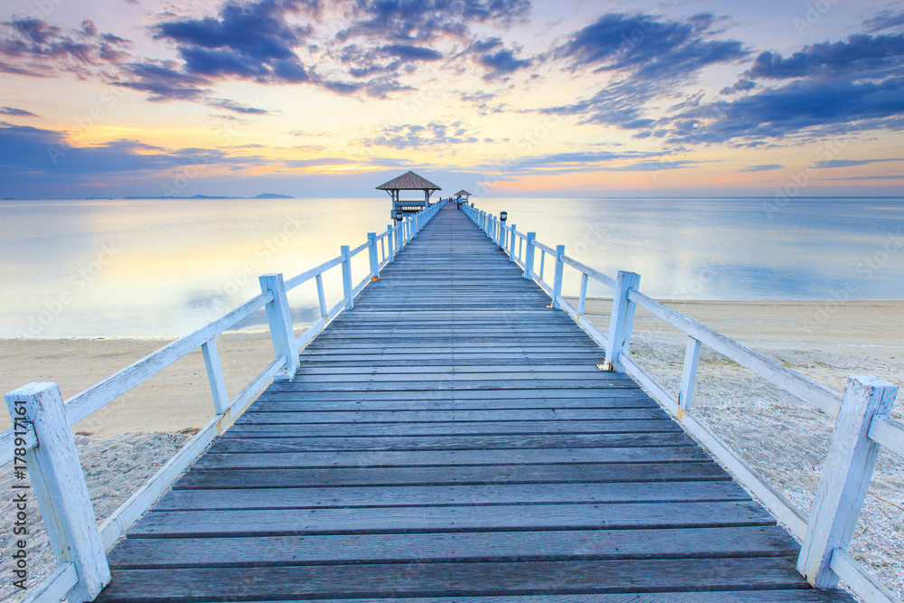 Old wood bridge pier  against beautiful sunset sky use for natural background ,backdrop and multipurpose sea scene