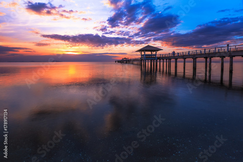 Old wood bridge pier against beautiful sunset sky use for natural background ,backdrop and multipurpose sea scene