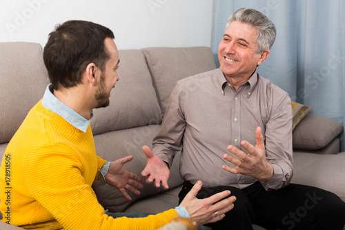Slika na platnu Adult father and son friendly conversation