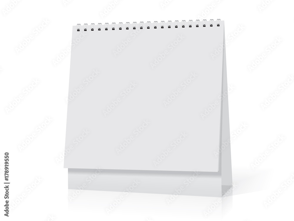 A paper white calendar stands on the table. A paper white calendar stands on the table.