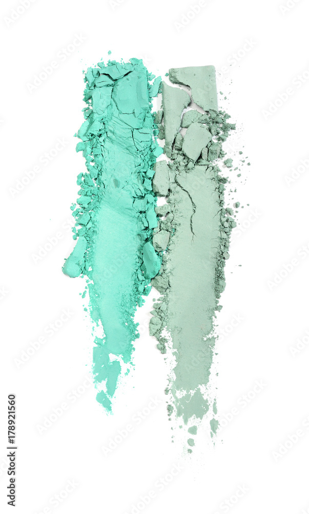 Smear of crushed green eyeshadow as sample of cosmetic product