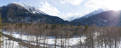 Winter panorama of the mountain with valleys and forest.