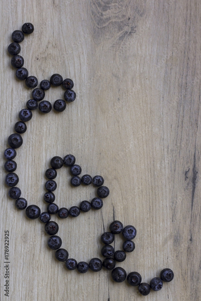 Blueberries on wooden background; Healthy heart symbol Blueberries on wooden background; Healthy heart symbol