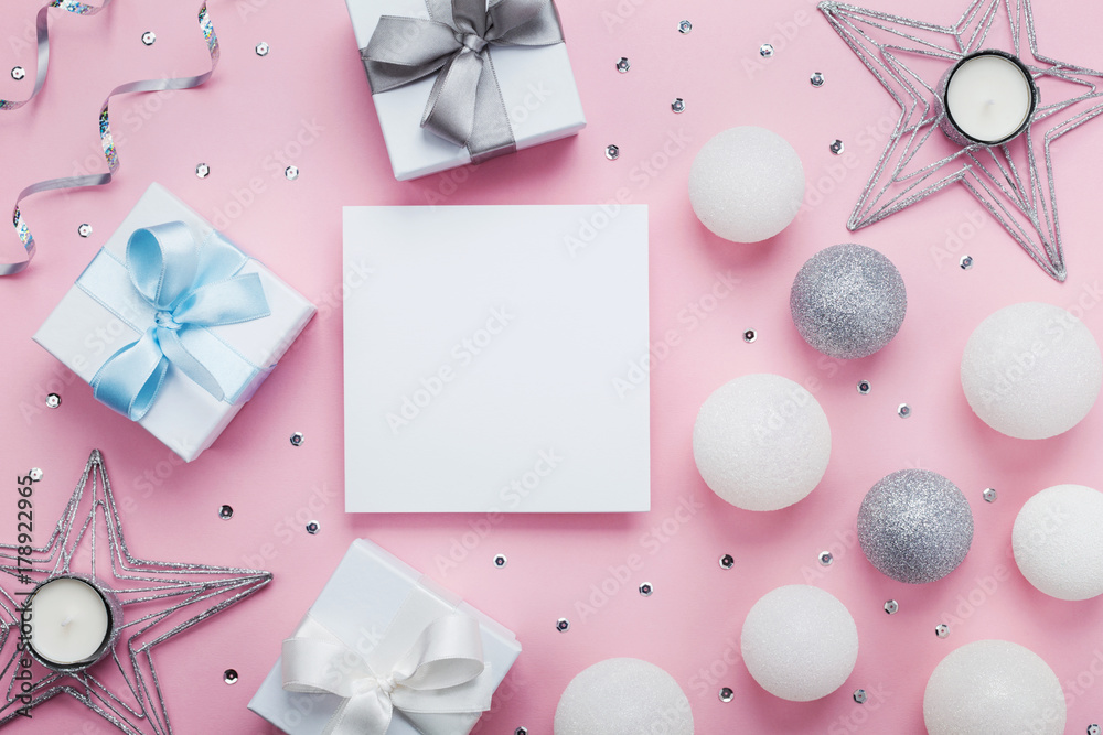 Empty paper blank, gift box and decoration on pink table top view. Christmas mockup or greeting card. Flat lay. Empty paper blank, gift box and decoration on pink table top view. Christmas mockup or greeting card. Flat lay.