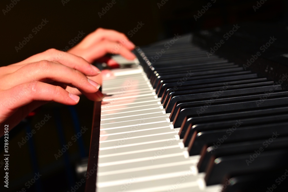 Piano lessons in a school: detail on hands.