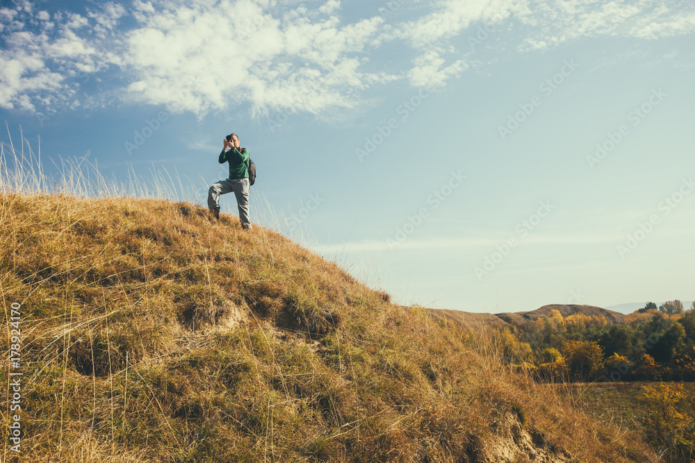 Photographer taking photos in mountain in autumn. Photographer taking photos in mountain in autumn.