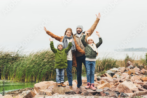family standing on rocky coast