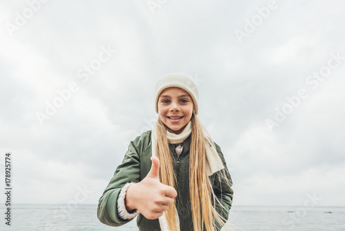 little girl showing thumb up