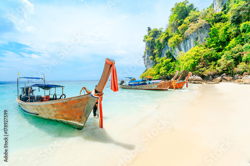 Longtale boat on the white beach at Phuket  Thailand. Phuket is a popular destination famous for its beaches.