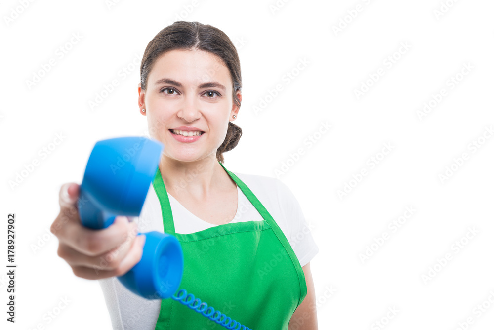 Young female employee holding phone receiver Young female employee holding phone receiver