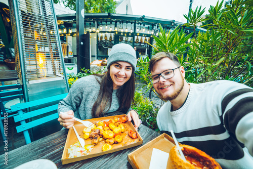 Photography couple eating in cafe outside