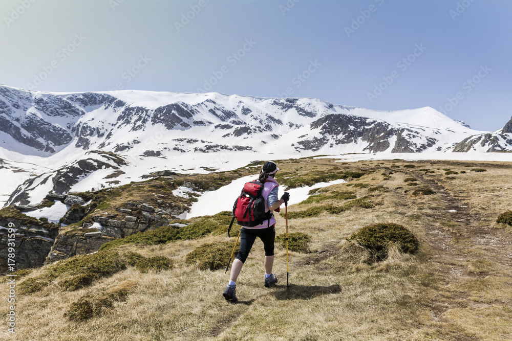 hiker woman on the top of a winter mountain with stunning view .RIla mountain,Bulgaria