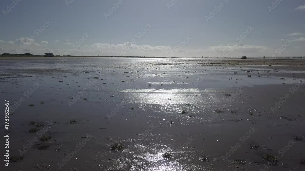 Aerial of Wadden island Fanø in Denmark – flying over the beach and sea - low angle view Aerial of Wadden island Fanø in Denmark – flying over the beach and sea - low angle view