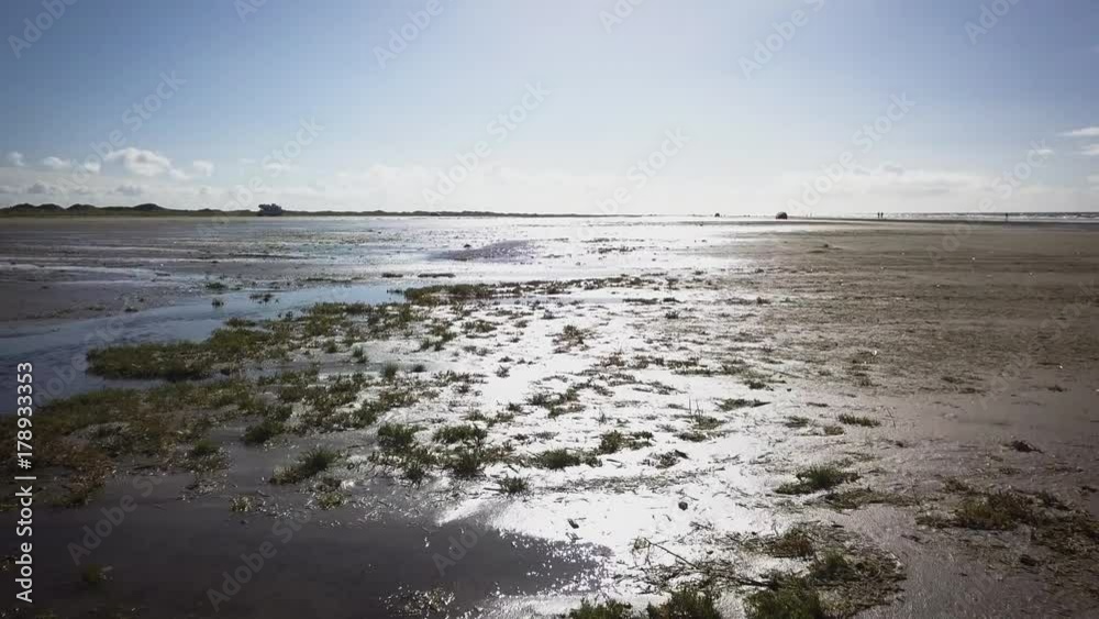 Aerial of Wadden island Fanø in Denmark – flying over the beach and sea - low angle view Aerial of Wadden island Fanø in Denmark – flying over the beach and sea - low angle view
