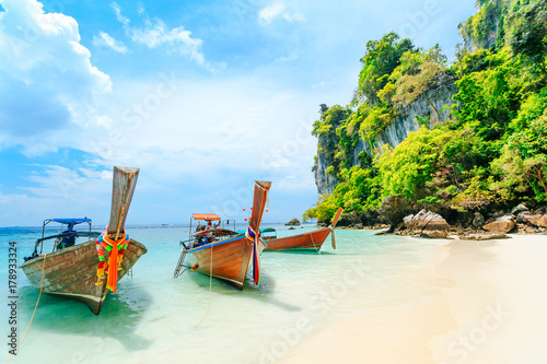 Longtale boat on the white beach at Phuket, Thailand. Phuket is a popular destination famous for its beaches. photo