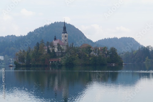 Saint Martin church in the fog on the island of Bled lake, Slovenia