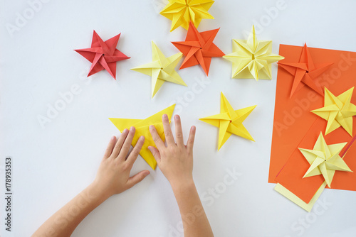 Lesson of origami. A Christmas star from paper