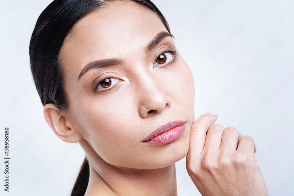 Close up of attractive brunette posing against white background Close up of attractive brunette posing against white background