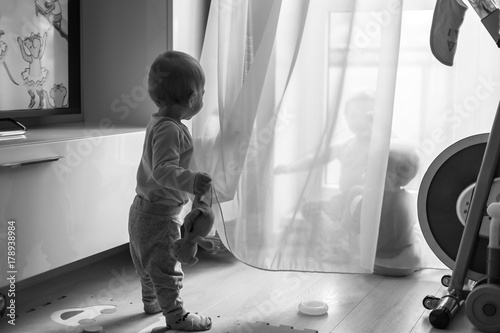 three sesters play with a curtain photo