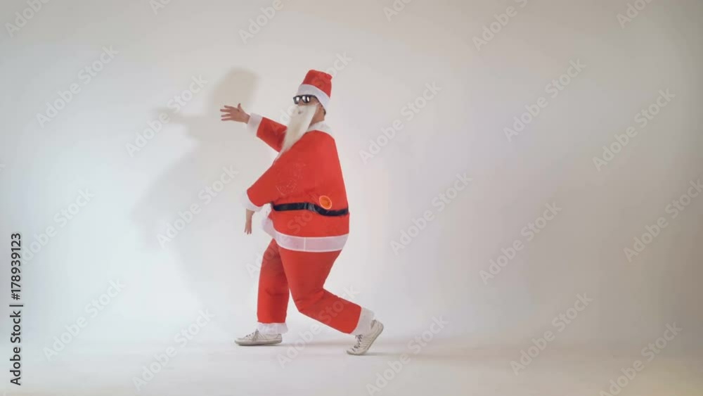 Junior funny thin Santa Claus dancing and having fun.