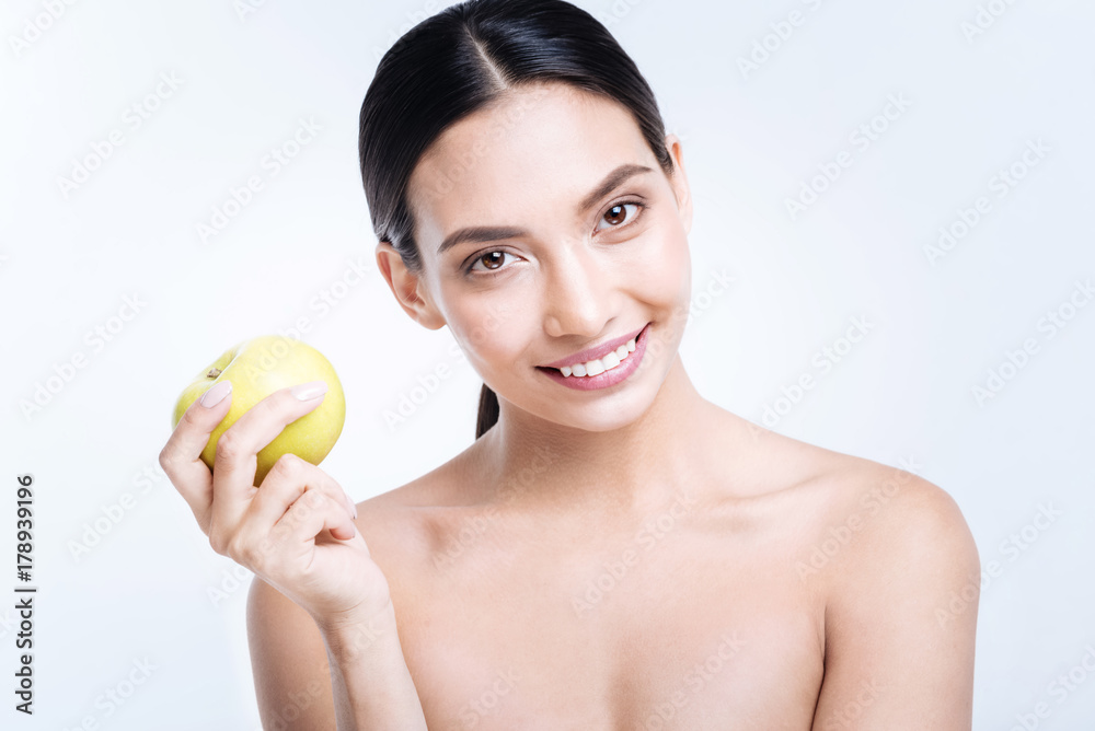 Cheerful woman holding yellow apple Cheerful woman holding yellow apple