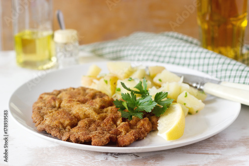 Schnitzel served with potato salad, lemon. Traditional Austrian food. photo