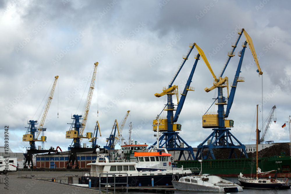 Blue and yellow port cargo cranes in the harbour