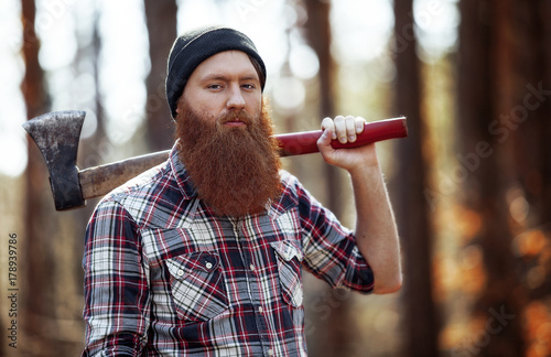 a lumberjack works with an axe in the forest