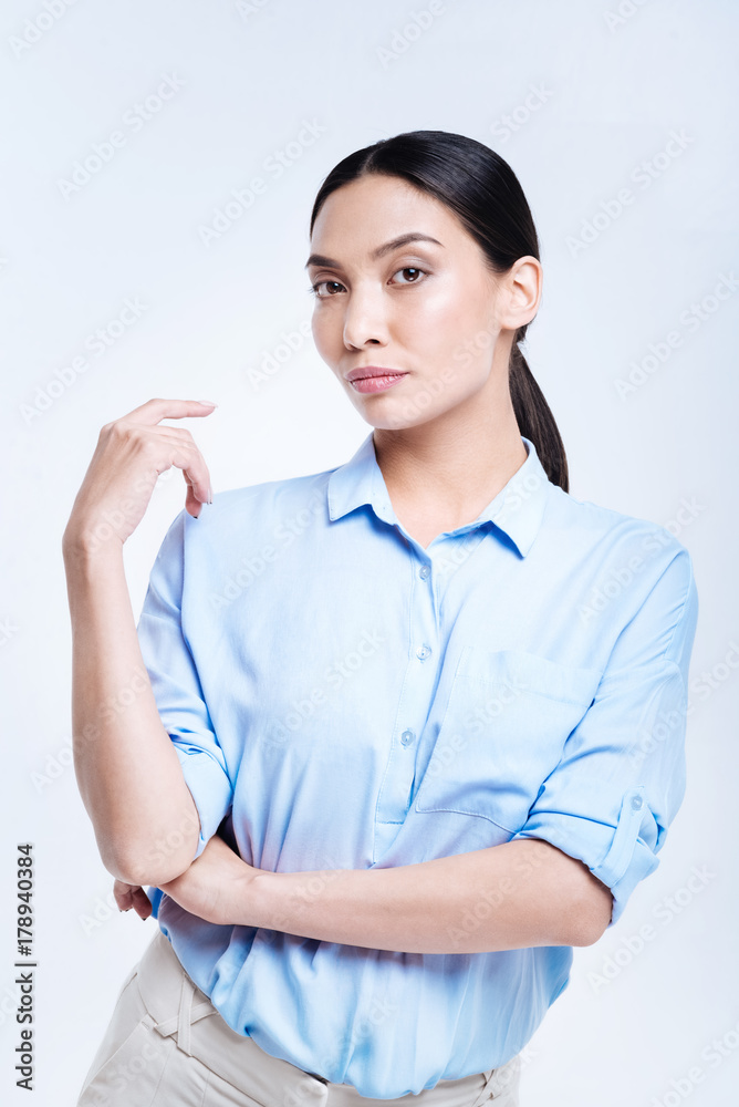 Gorgeous woman in blue shirt posing against white background Gorgeous woman in blue shirt posing against white background
