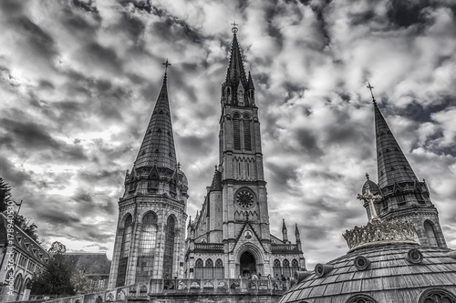Sanctuary of Our Lady of Lourdes against the sky. France. Black and white photo