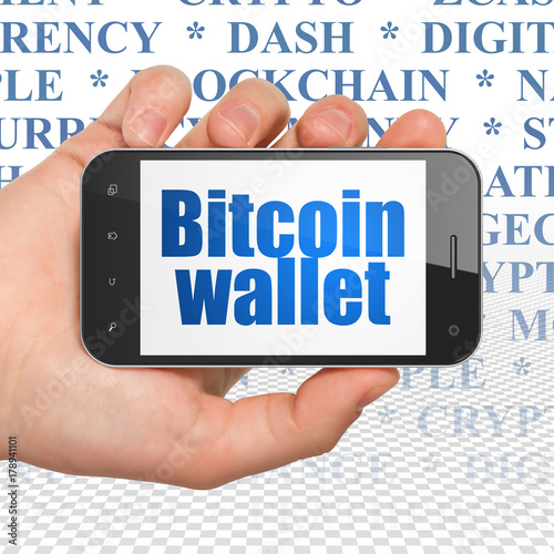 Blockchain concept: Hand Holding Smartphone with blue text Bitcoin Wallet on display, Tag Cloud background, 3D rendering