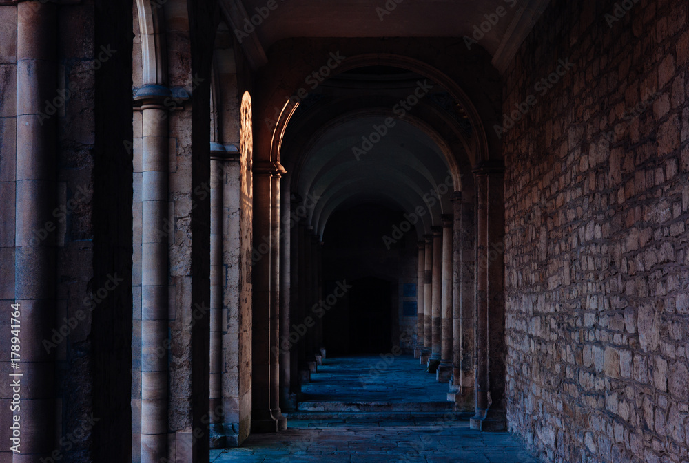 A fence casts shadows on a wall among gothic arches. Oxford, UK. A fence casts shadows on a wall among gothic arches. Oxford, UK.