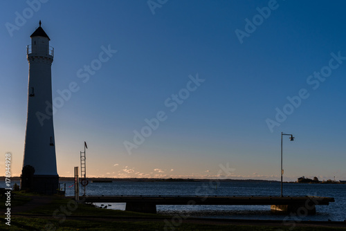 Lighthouse and pier at dawn. Location Stumholmen in Karlskrona, Sweden.