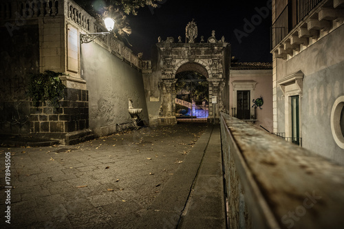 The entrance to Villa Cerami  home of the faculty of Law  on the Street Crociferi photographed at night - Catania  Sicily  Italy.