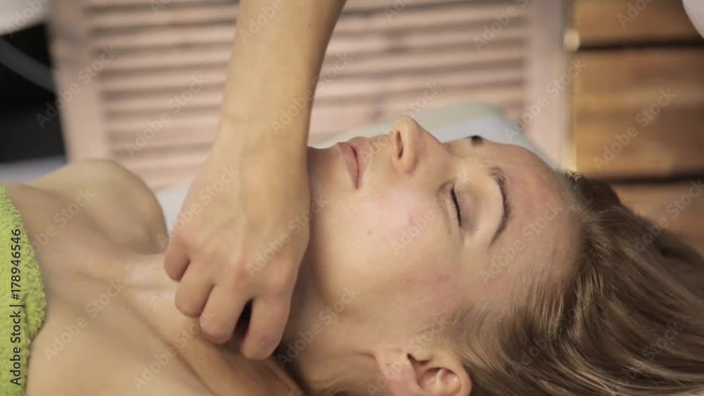 Massage scraper gouache. masseur makes acupressure on a female face. Chinese alternative medicine Massage scraper gouache. masseur makes acupressure on a female face. Chinese alternative medicine