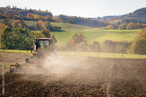 Tractor Ploughing on the Field photo